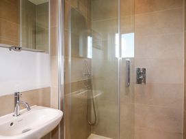 A bathroom with a shower and sink at Lavender House in Crantock