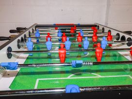 A foosball table with blue and red players at Lavender House Crantock
