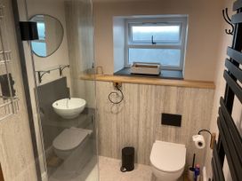 A bathroom with a shower, toilet, and sink at Woodbine Cottage in Mylor Bridge, Nr Falmouth