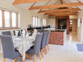 A kitchen with a dining area and a breakfast bar at The Stables at Hall Barn Wattisfield near Walsham-Le-Willows
