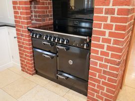 A stove with an oven in a kitchen at The Stables at Hall Barn Wattisfield near Walsham-Le-Willows