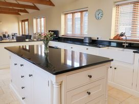 A kitchen with an island and sink at The Stables at Hall Barn Wattisfield near Walsham-Le-Willows