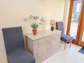 An entrance hall with a table and two chairs at The Stables at Hall Barn near Wattisfield near Walsham-Le-Willows