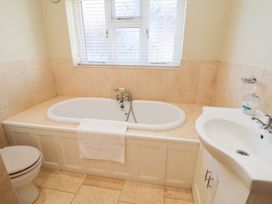 A bathroom with a bathtub and sink at The Stables at Hall Barn Wattisfield near Walsham-Le-Willows