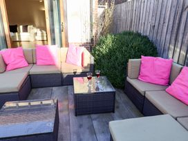 A seating area with a table and sofas at The Stables at Hall Barn Wattisfield near Walsham-Le-Willows