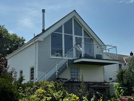 A house with a balcony and garden at Spires Playing Place near Carnon Downs
