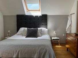 A bedroom with a bed and side table at Spires in Playing Place near Carnon Downs