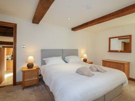 A bedroom with a bed and furniture at Birchenhayes St Dominick