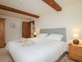 A bedroom with a bed and bedside table at Birchenhayes St Dominick