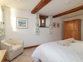 A bedroom with a bed and wardrobe at Birchenhayes St Dominick