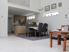 A dining room with a table and chairs at Narracott Down in South Molton