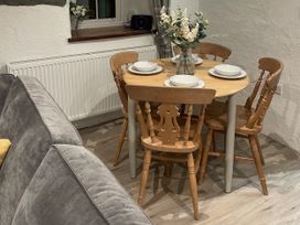 A dining room with a table set for meals at Old Chapel House in Llanfairfechan