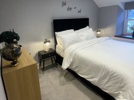 A bedroom with a bed and nightstand at Old Chapel House Llanfairfechan