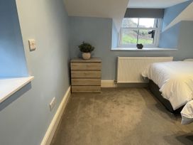 A bedroom with a bed and a nightstand at Old Chapel House in Llanfairfechan