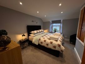 A bedroom with a bed and nightstand at Old Chapel House in Abergwyngregyn near Llanfairfechan