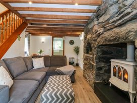 A living room with a fireplace and sofa at Old Chapel House Abergwyngregyn near Llanfairfechan