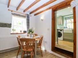 A dining room with a table and chairs at Old Chapel House in Abergwyngregyn near Llanfairfechan
