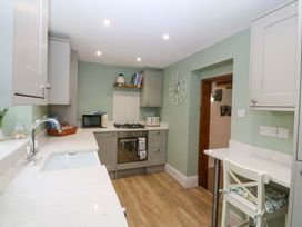 A kitchen with appliances and furniture at Old Chapel House Abergwyngregyn near Llanfairfechan