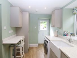 A kitchen with a washing machine and sink at Old Chapel House Abergwyngregyn near Llanfairfechan