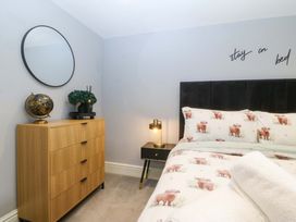 A bedroom with a bed and nightstand at Old Chapel House Abergwyngregyn near Llanfairfechan