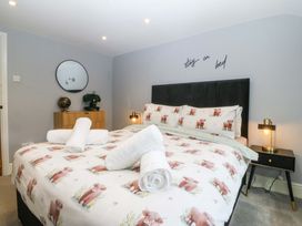 A bedroom with a bed and side table at Old Chapel House in Abergwyngregyn near Llanfairfechan