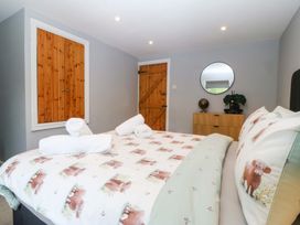 A bedroom with a double bed and wooden furniture at Old Chapel House Abergwyngregyn near Llanfairfechan