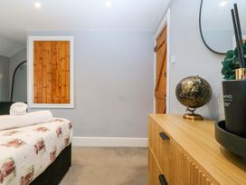 A bedroom with a bed and storage cabinet at Old Chapel House Abergwyngregyn near Llanfairfechan