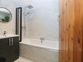 A bathroom with a bathtub and sink at Old Chapel House Abergwyngregyn near Llanfairfechan