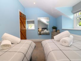 A bedroom with two beds and towels at Old Chapel House Abergwyngregyn near Llanfairfechan