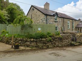 A house with stone wall and green fence at Old Chapel House Abergwyngregyn near Llanfairfechan