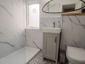 A bathroom with a shower and sink at Riverdance Cottage in Lyme Regis