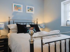 A bedroom with a bed and bedside table at Riverdance Cottage in Lyme Regis