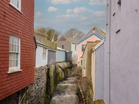 A view of buildings along a water stream at Riverdance Cottage in Lyme Regis
