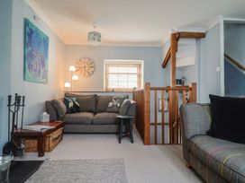 A living room with a sofa and coffee table at Riverdance Cottage in Lyme Regis