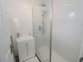 A bathroom with a white sink vanity and a glass-enclosed shower at New House Farm in Wappenbury near Leamington Spa