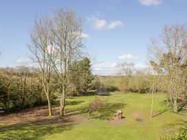 A backyard with trees a small soccer goal and a trampoline at New House Farm in Wappenbury near Leamington Spa