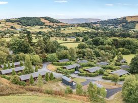 A view of lodges and landscape at Tawny Owl Lodge in Rhayader