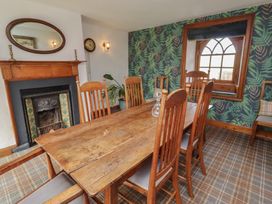 A dining room with a wooden table and chairs at The Coach House near Crookham-On-Tweed