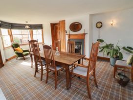 A dining room with a table and chairs at The Coach House Crookham near Cornhill-On-Tweed