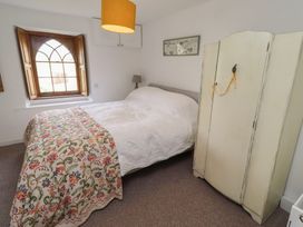 A bedroom with a bed and wardrobe at The Coach House Crookham near Cornhill-On-Tweed