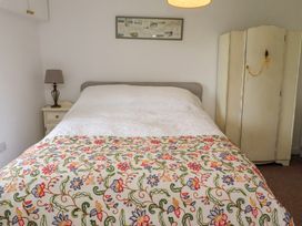 A bedroom with a bed and nightstand at The Coach House in Crookham near Cornhill-On-Tweed