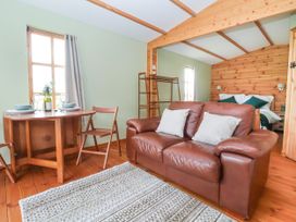 A living room with a couch and dining table at Lodge 1 in York