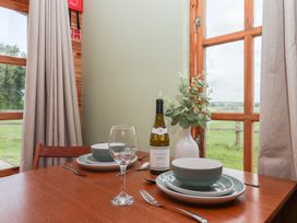 A dining table set with wine and plates at Lodge 1 in Strensall