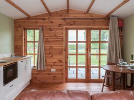A kitchen area with table and chairs at Lodge 3 in Strensall