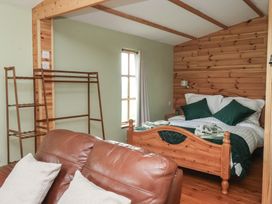 A bedroom with a bed and sofa at Lodge 3 in Strensall