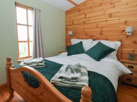 A bedroom with a bed and a window at Lodge 3 in Strensall