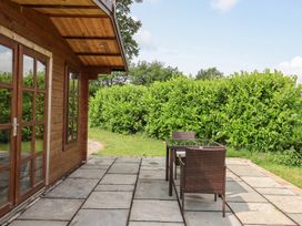 A patio area with a table and chairs at Lodge 3 in Strensall