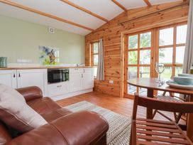 A living room with a kitchen unit and dining area at Lodge 3 in Strensall