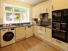 A kitchen with a washing machine and sink at 7 Lonsdale Terrace in Penrith