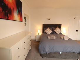 A bedroom with a bed and chest of drawers at 7 Lonsdale Terrace Penrith